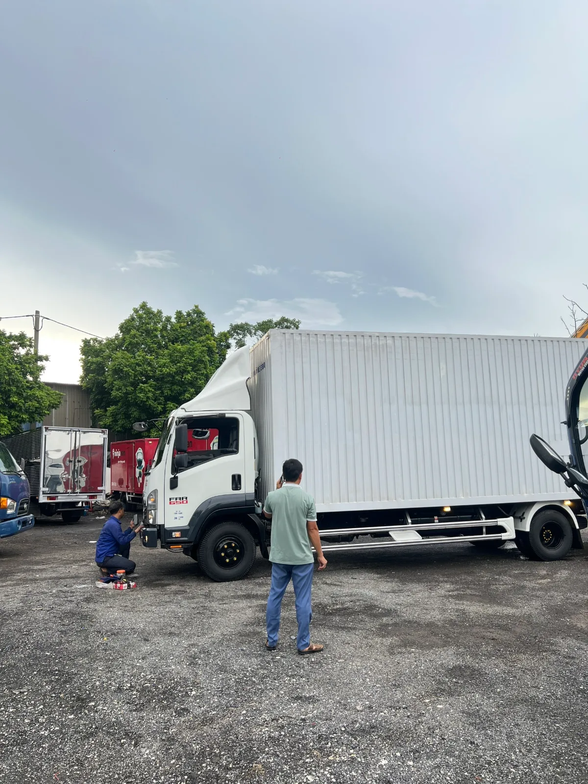 Thợ kỹ thuật kiểm tra và bảo dưỡng xe tải cũ trước khi xuất bãi tại Bãi xe Thắng Cảnh